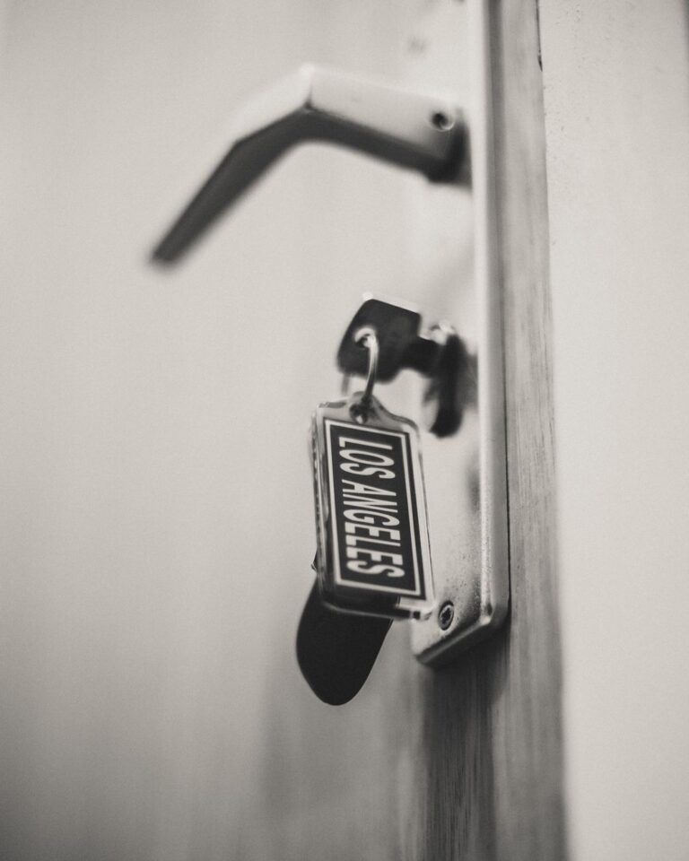 A black-and-white close-up of a key in a door lock, symbolizing boundaries and security.